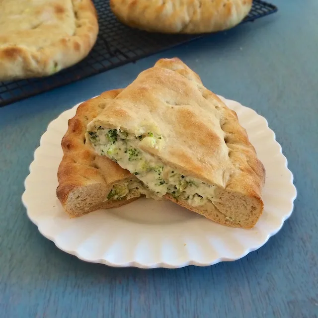 Stuff roasted broccoli with white pizza toppings (ricotta, mozzarella & Parmesan) to make these homemade calzones that are pizza parlor worthy. Teaspoonofspice.com @tspbasil