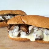 Grilled mushrooms and grilled onions with a light cheese sauce makes for the ultimate veggie cheesesteak. Recipe at Teaspoonofspice.com