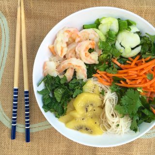 Perfect for hot weather, this gluten-free shrimp noodle salad has a surprising ingredient: SunGold Kiwifruit! [sponsored]