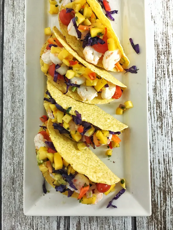 Get more fruit and vegetables into your lunch or dinner with these delicious shrimp tacos. Recipe at Teaspoonofspice.com