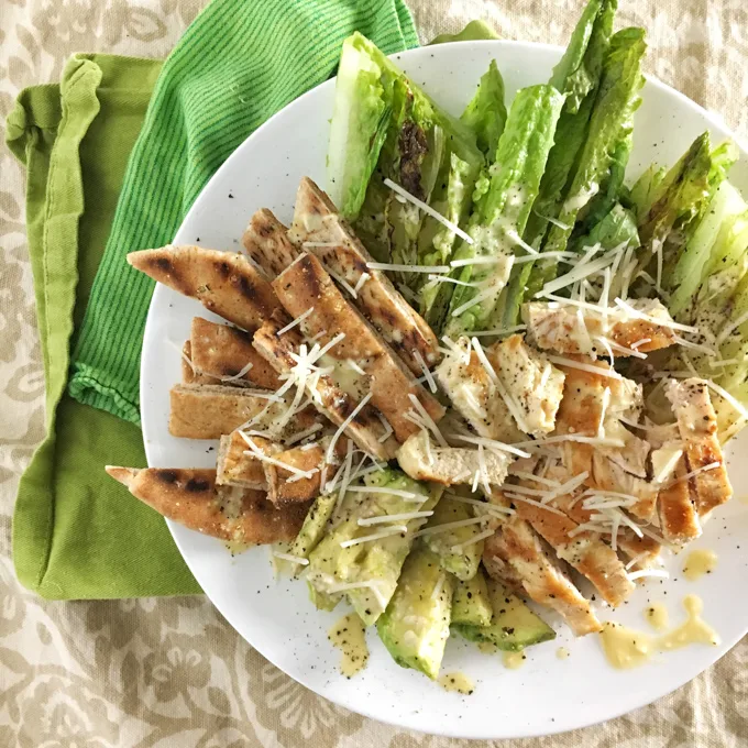 Swap your croutons for grilled pita bread strips with this better-for-you Chicken Caesar Salad. Recipe at Teaspoonofspice.com