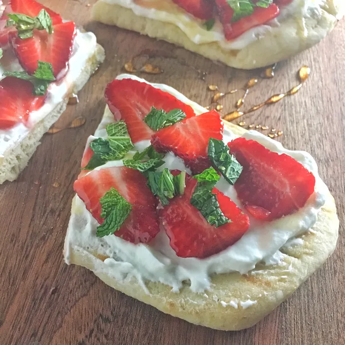 An easy-to-make, not-too-sweet dessert featuring strawberries, whipped cream, yogurt, honey and naan flatbread.