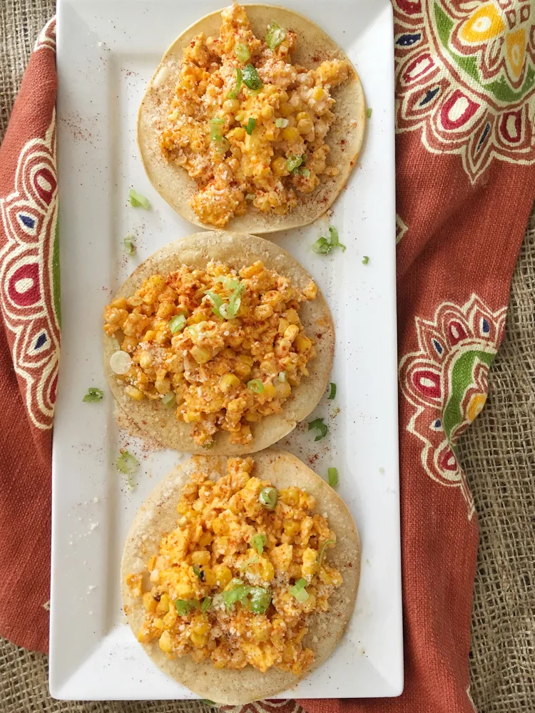 The famous grilled Mexican street corn meets eggs and tortillas in this breakfast mash-up recipe. Recipe at TeaspoonofSpice.com