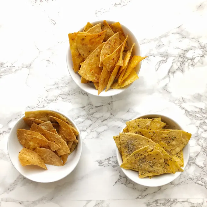 You can make tortilla snack chips at home in your oven or microwave. Check out our hacks for salted, ranch and nacho cheese flavors! Recipes at Teaspoonofspice.com