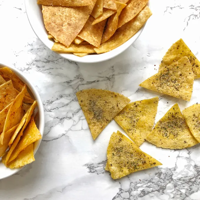 You can make tortilla snack chips at home in your oven or microwave. Check out our hacks for salted, ranch and nacho cheese flavors! Recipes at Teaspoonofspice.com