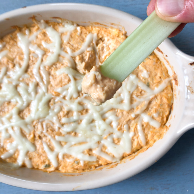 This buffalo chicken cheese dip is a crowd-pleaser and no one will miss the extra calories from the original. Recipe at Teaspoonofspice.com
