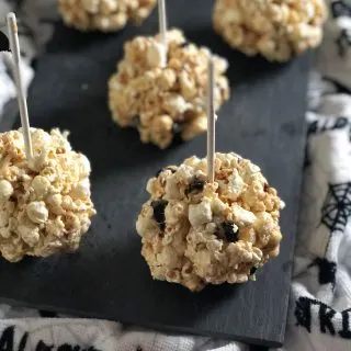 Add peanut butter, dried cherries and seeds to add a bit of nutrition to popcorn balls for Halloween. #sponsored #aldi #halloween #recipes #popcorn