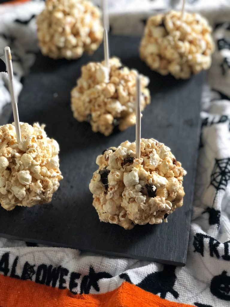 Add peanut butter, dried cherries and seeds to add a bit of nutrition to popcorn balls for Halloween. #sponsored #aldi #halloween #recipes #popcorn
